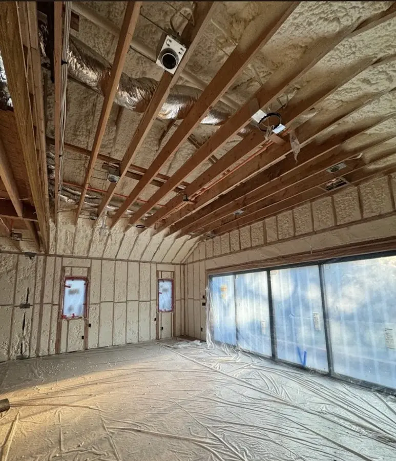Interior walls and ceiling insulated with spray foam during new construction in Upper Milford